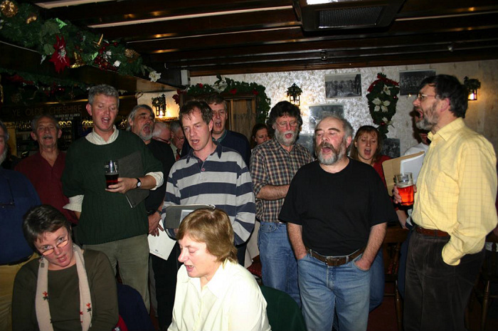 Carolling at the Cheshire Cheese, Castleton, 19 December 2004. Photograph: Derek Schofield.